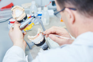 Prosthodontist working with dental prosthesis